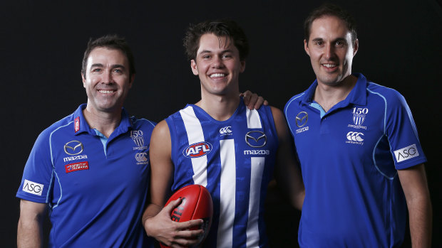 Cameron Joyce (right) poses with coach Brad Scott and Roos recruit Curtis Taylor last year.