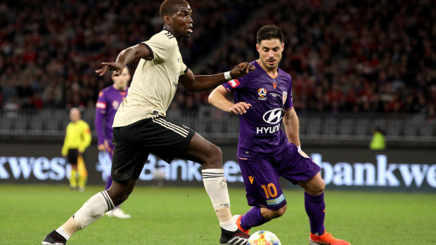 Paul Pogba of Manchester United and Bruno Fornaroli of the Glory in action at Optus Stadium.