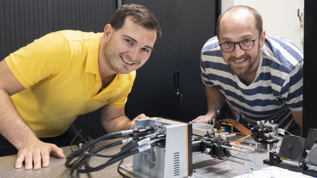 UQ’s Dr Mickael Mounaix (left) and Dr Joel Carpenter with the splitter device developed in collaboration with Nokia Bell Labs.
