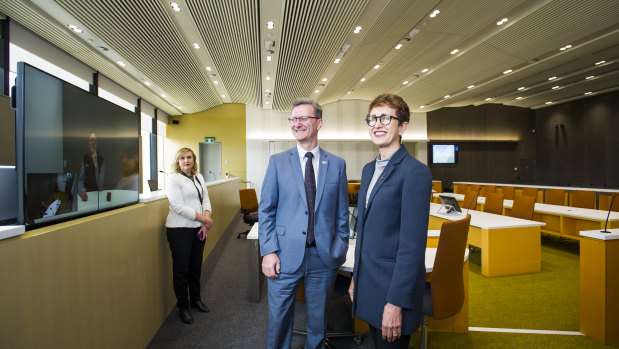 Chief Justice, Helen Murrell shows attorney general, Gordon Ramsay around the new court room's advanced technology. Pictured with in court technology officer, Drani Sarkozi.
