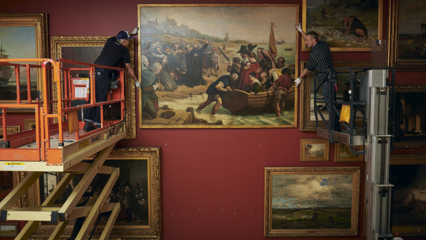 A painting restored during the coronavirus lockdown is installed at the NGV.