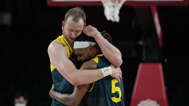 Patty Mills embraces teammate Joe Ingles at the Tokyo 2020 Olympics.