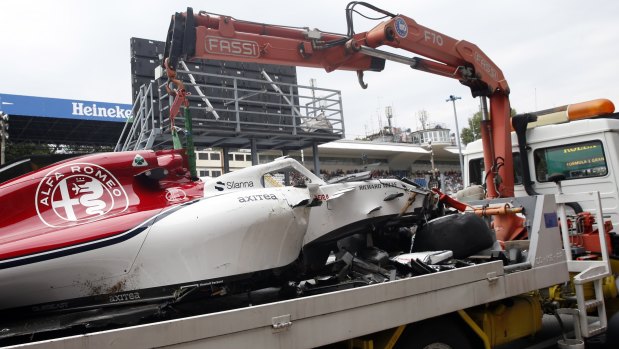 Write-off: The car of Sauber driver Marcus Ericsson of Sweden is carried away by a truck.
