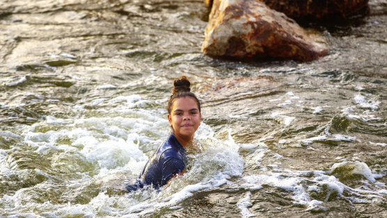 A girl swims in the Brewarrina Weir, in northern NSW, which leads into the Murray-Darling basin, after heavy rain in February.