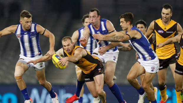 Hunting in packs: Congestion around the footy has become a more common feature over past years, says the Hawks coach.