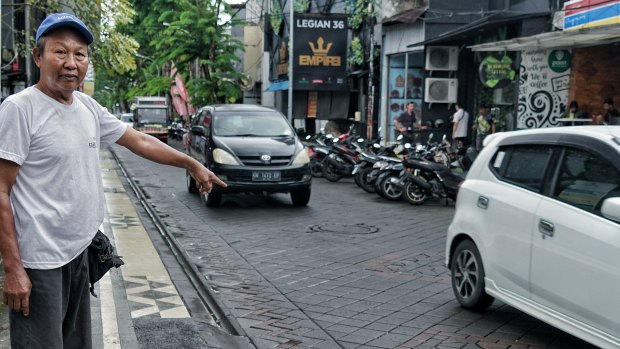 Made Kana points to the spot where the car bomb outside the Sari Club exploded.