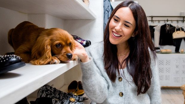 Jenna Isaacman with her 4-month-old cavoodle, Teddy, at her business 'Trading in Style' in Randwick. 