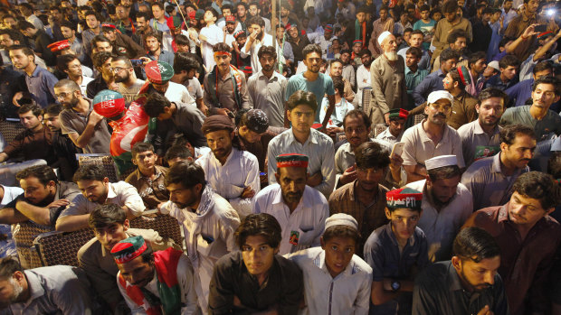 Supporters listen to Imran Khan during an election campaign rally in Islamabad, Pakistan.