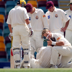 Andy Bichel of Queensland cradles Justin Langer of Western Australia in his arms after Langer was hit in the head by a bouncer bowled by Bichel during the Pura Cup cricket match between Queensland and Western Australia in 2001.