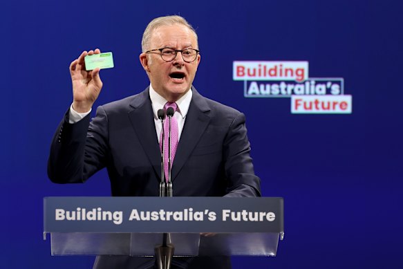 Anthony Albanese holds up his Medicare card during Labor’s campaign launch on Sunday.