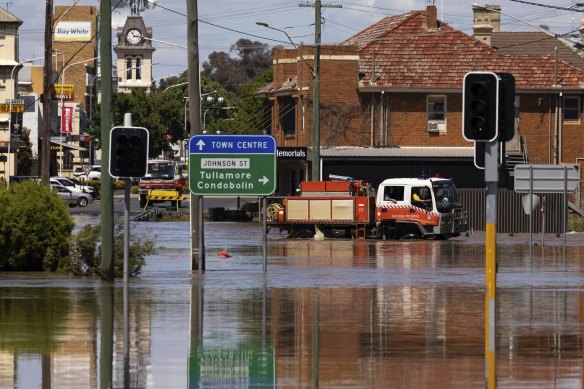 RFS vehicles tranporting people across flooded streets in Forbes on Friday.