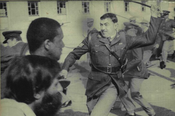 Police attack a crowd protesting apartheid in Cape Town, South Africa in 1985.
