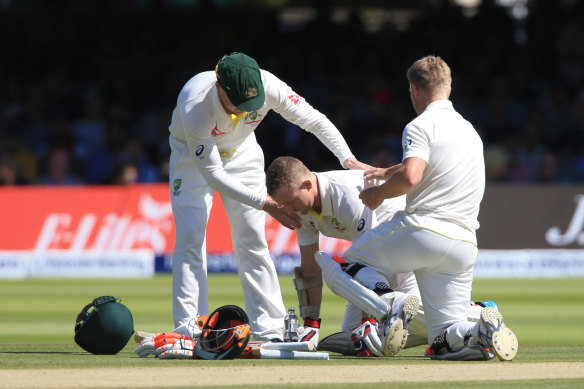 Chris Rogers (centre) steadies himself after copping a nasty blow at Lord's.
