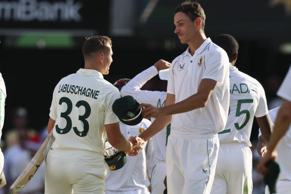 Marnus Labuschagne shakes hands with Jansen following the conclusion of the first Test in Brisbane.