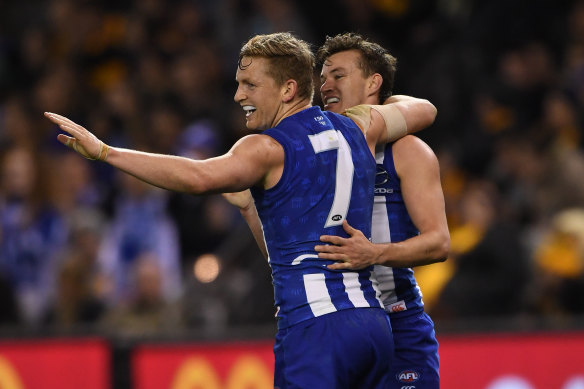 What a feeling: North Melbourne’s Jack Ziebell celebrates a goal with Kayne Turner last night. 
