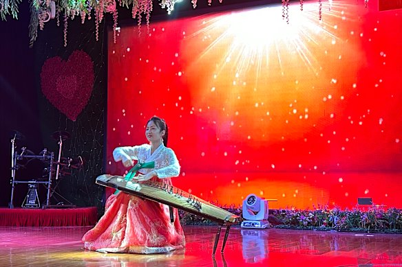 A North Korean performer plays the Gayageum, a 12-stringed traditional Korean musical instrument.