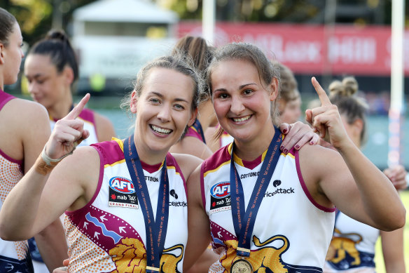 Lauren Arnell (left) with premiership teammate Breanna Koenen after the 2021 grand final in Adelaide.