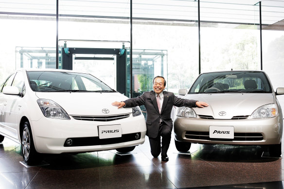  The Prius became a hit: Takeshi Uchiyamada poses with the hybrid cars in 2013 to celebrate sales exceeding 5 million.