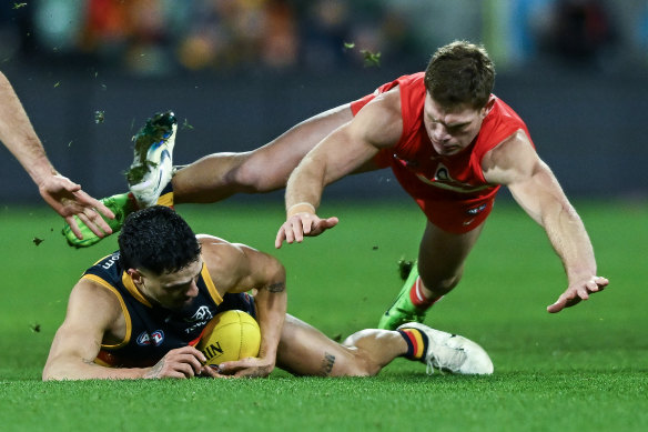 Izak Rankine of the Crows competes with Taylor Adams of the Swans.