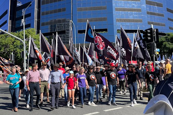 Former premier Steven Miles – pictured with his daughter and fellow state MPs – led the annual Labour Day march in Brisbane last year.