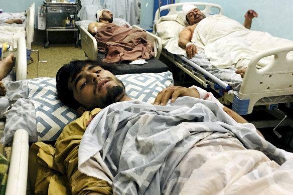 Wounded Afghans lie in hospital after the deadly explosions outside the airport in Kabul.
