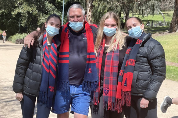 Demons fan Mike McShane and his daughters Georgia, Zoe and Emma took to the Tan in South Yarra.