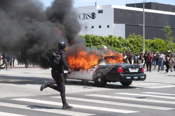 A police car burns during protests in Los Angeles over the death of George Floyd.