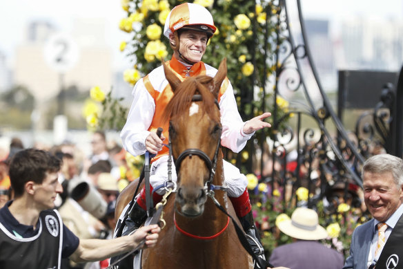 Jockey Craig Williams and part-owner Geoff Corrigan, right, with Vow And Declare at Melbourne Cup. 