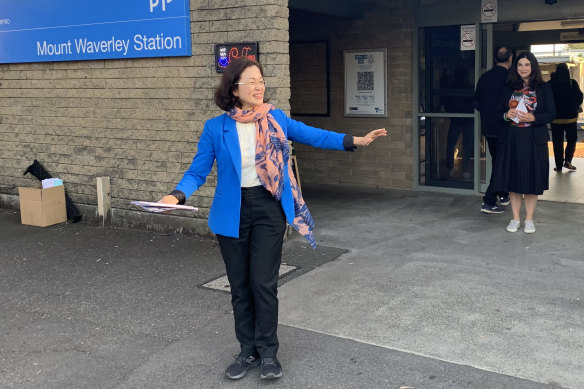 Chisholm Liberal MP Gladys Liu, in blue, and Labor candidate Carina Garland, at Mount Waverley railway station.