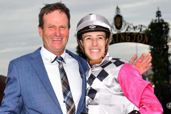 Trainer Paul Preusker poses with jockey Jordan Childs after Surprise Baby's win in The Bart Cummings, which guarantees him a spot in the Melbourne Cup.