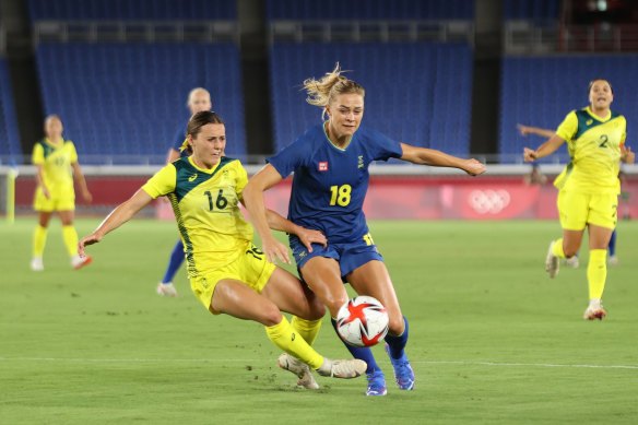Sweden’s Fridolina Rolfo (right) is challenged by Hayley Raso.