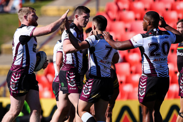 Blacktown Workers Sea Eagles players celebrate a try.