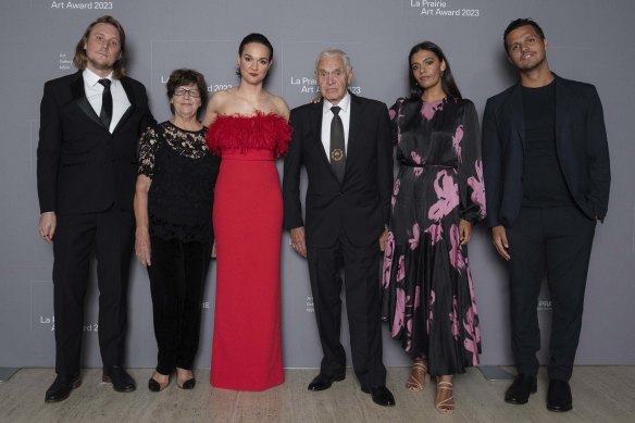 Family affair: Madeleine Madden (second from right) with her sister Thea Anamara Perkins (in red) and (from left) Thea’s partner Adam Finney, grandmother Eileen Perkins, Charles Madden (grandfather), and brother Tyson Perkins.