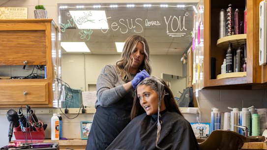 Amber Wheeler colours client Whitney Barnes’ hair in her salon, Steel Magnolia, in the Kentucky town of Magnolia.