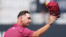 Lucas Herbert of Australia acknowledges the crowd on the 18th green following his round of 62.