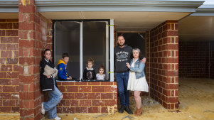 Zoe-Marie and Joel Masters with their children Temperance (12), Max (10), Grace (4) and Lilly (2) outside their unfinished home in Mandogalup.