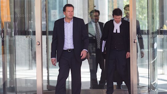 Mark Elliott (left) and Michael Symons (in robes) leave court in 2019.