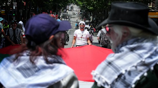 Demonstrators during the pro-Palestinian rally in Melbourne’s CBD on Sunday, hours before the Gaza ceasefire came into force.
