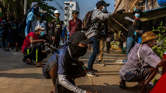 Anti-coup protesters prepare to use slingshots against security forces during clashes in March. 