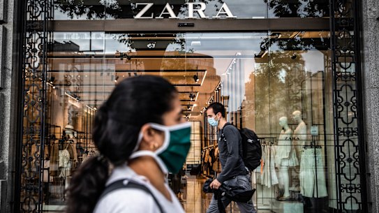 Pedestrians wear protective face masks in Barcelona, Spain. 