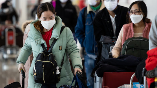 Passengers wear protective masks at Incheon International Airport in South Korea.