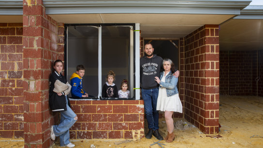 Zoe-Marie and Joel Masters with their children Temperance (12), Max (10), Grace (4) and Lilly (2) outside their unfinished home in Mandogalup.