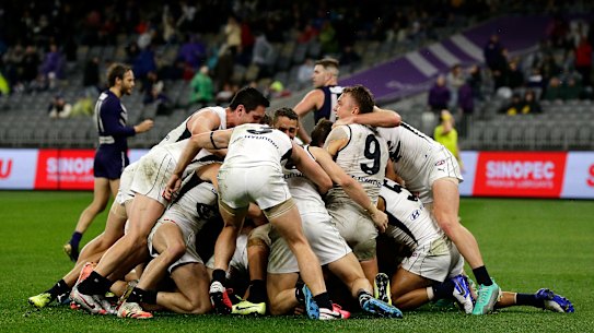 15: The Blues celebrate after Jack Newnes scores a goal after the siren to win the match during the 2020 AFL Round 12 match between the Fremantle Dockers and the Carlton Blues at Optus Stadium on August 15, 2020 in Perth, Australia. (Photo by Will Russell/AFL Photos via Getty Images)
