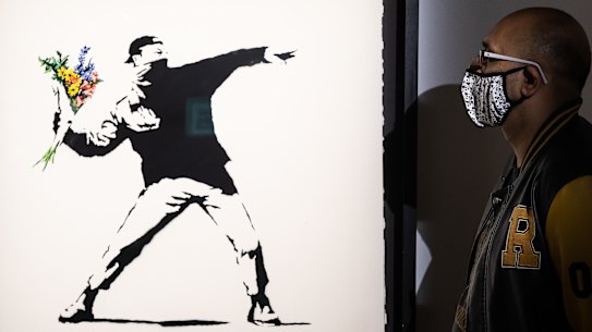 Banksy’s “flower bomber” in action.