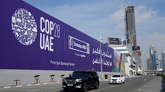 Cars pass by a billboard advertising COP28 at Sheikh Zayed highway in Dubai, United Arab Emirates, Monday, Nov. 27, 2023. Representatives will gather at Expo City in Dubai, UAE, Nov. 30 to Dec. 12 for the 28th U.N. Climate Change Conference, known as COP28.