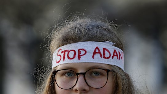 An activist wears an anti-Adani slogan during a protest against Siemens in Munich, Germany, on Friday.