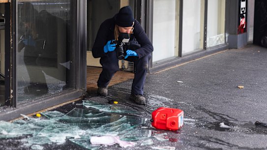 Investigators scour through evidence at the scene of a suspicious fire in Collingwood on Thursday morning.