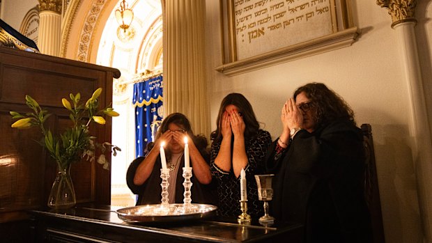 Janice Furstenberg (left), Rebbetzin Rachel Gutnick and Jenny Segal at the East Melbourne Synagogue, lighting candles to bring in Shabbat.