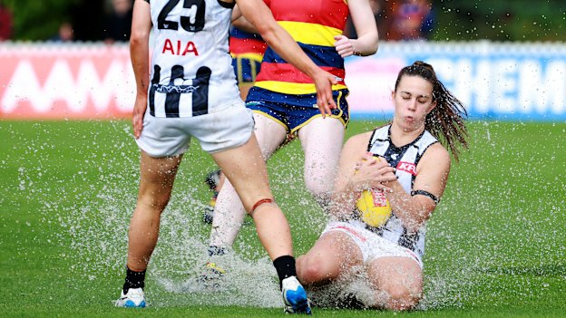 Football or swimming? Collingwood’s Chloe Molloy takes a sliding mark against Adelaide.