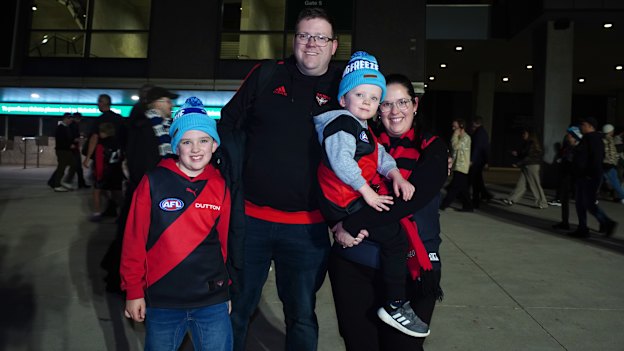 Essendon fans (from left) Henry, Jason, Darcy Poynter and Sarah Poynter outside the MCG.